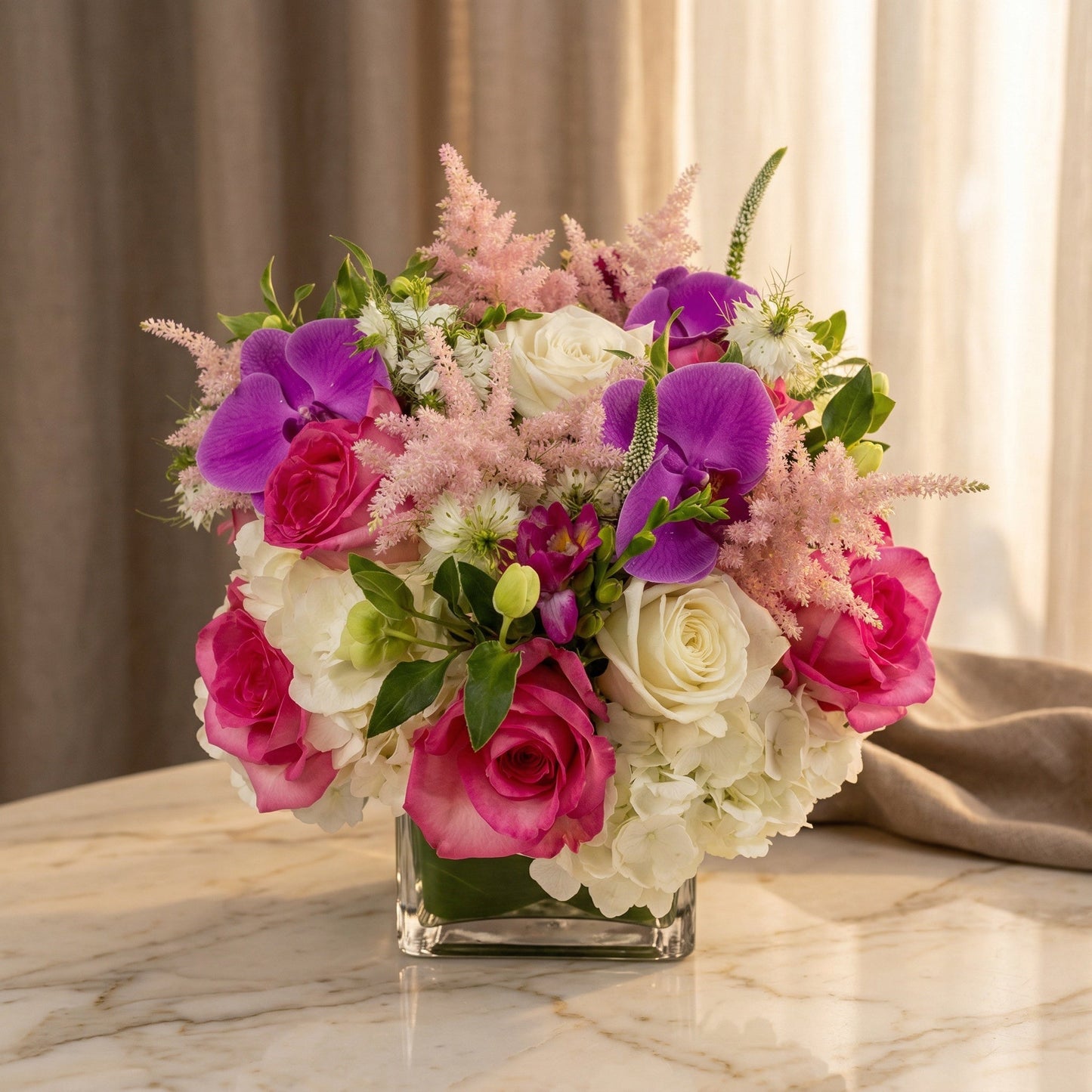 Pink and white roses, purple orchids, and hydrangeas in a square glass vase - TJ Flowers NYC