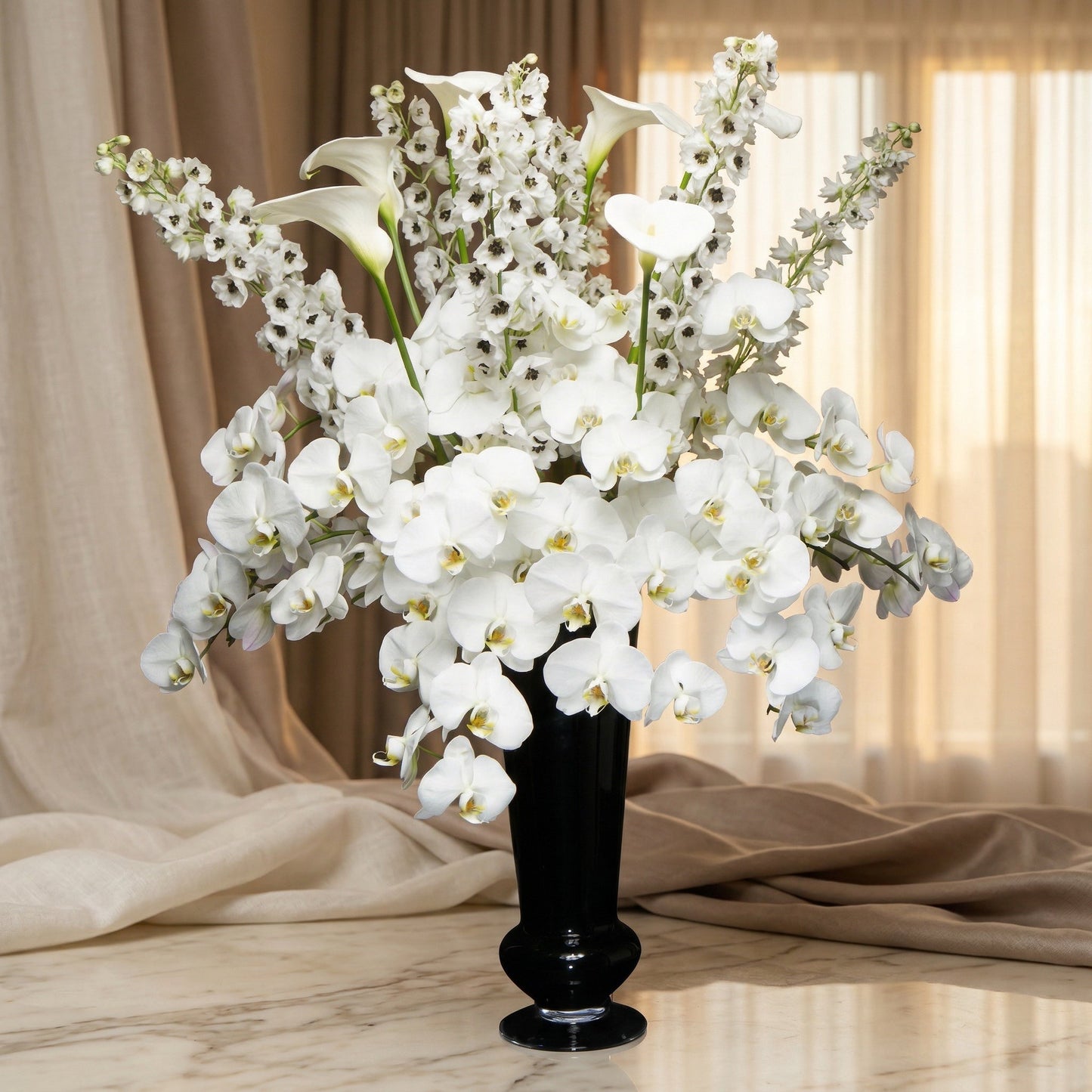 Elegant white phalaenopsis orchids and delphinium in a sleek black vase - TJ Flowers NYC