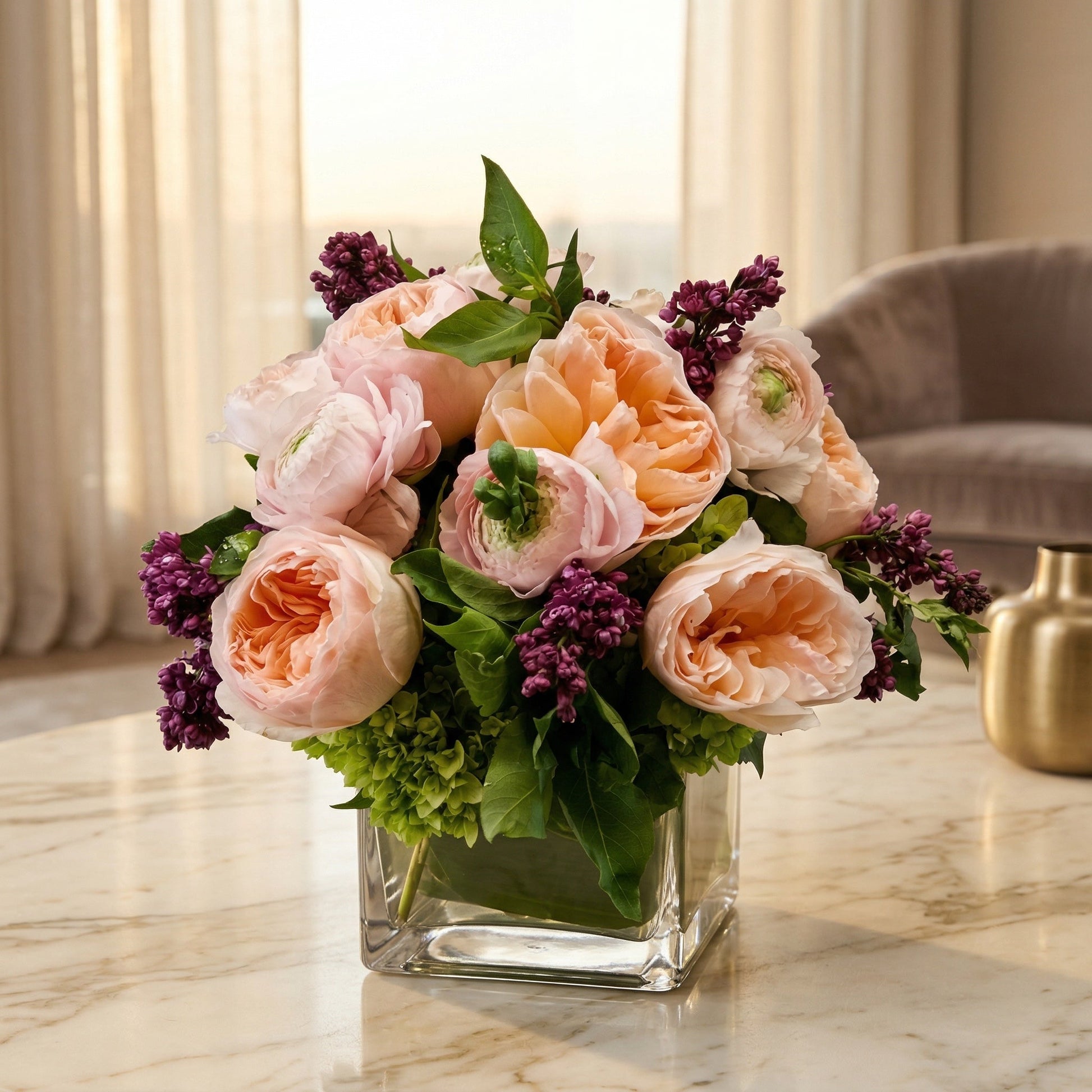 Pastel peach and pink roses with purple lilac in a square glass vase - TJ Flowers NYC