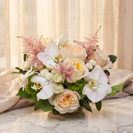 White phalaenopsis orchid blooms with cream garden roses, blush astilbe and green hydrangea - TJ Flowers NYC