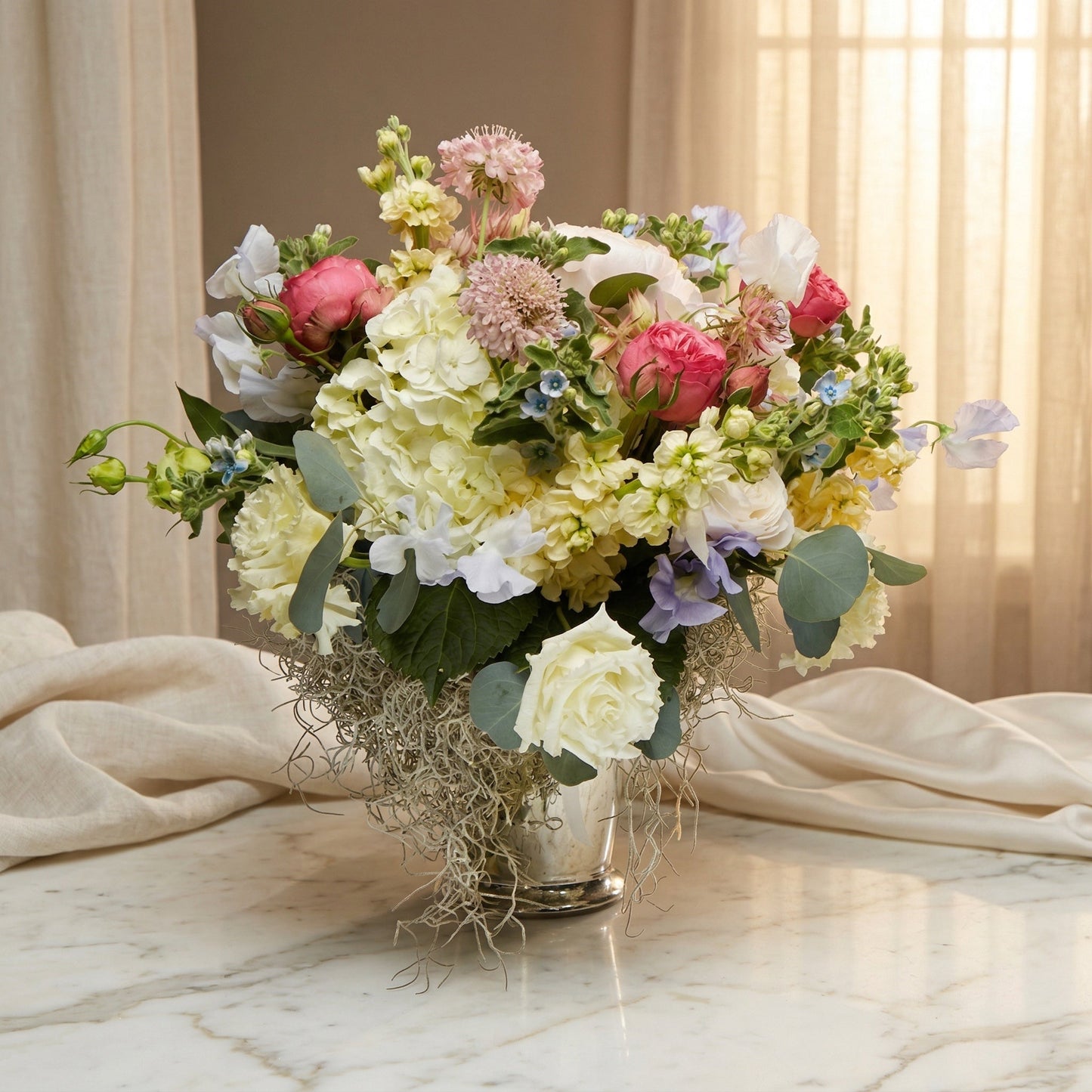 Pastel bouquet with roses, hydrangeas, and sweet peas in a silver vase with Spanish moss - TJ Flowers NYC