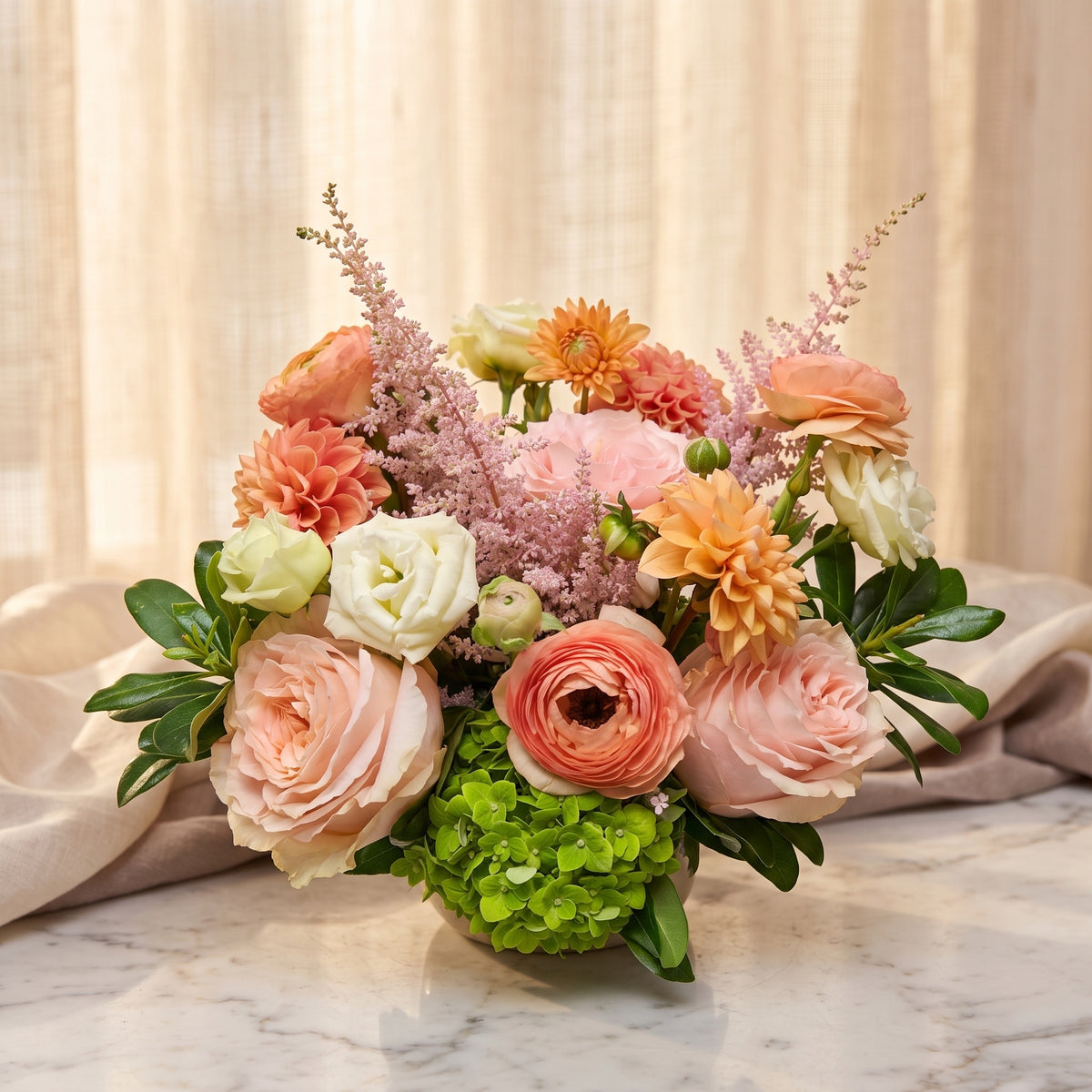 Peach garden roses with apricot ranunculus, peach dahlias, blush astilbe and green hydrangea - TJ Flowers NYC