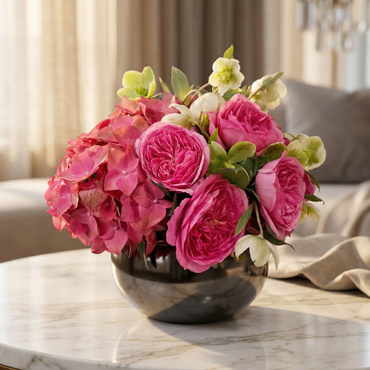 Vibrant pink garden roses and hydrangea in a dark reflective bowl vase - TJ Flowers NYC