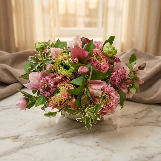 Pink and green mixed bouquet with ranunculus and hellebores in a white bowl - TJ Flowers NYC