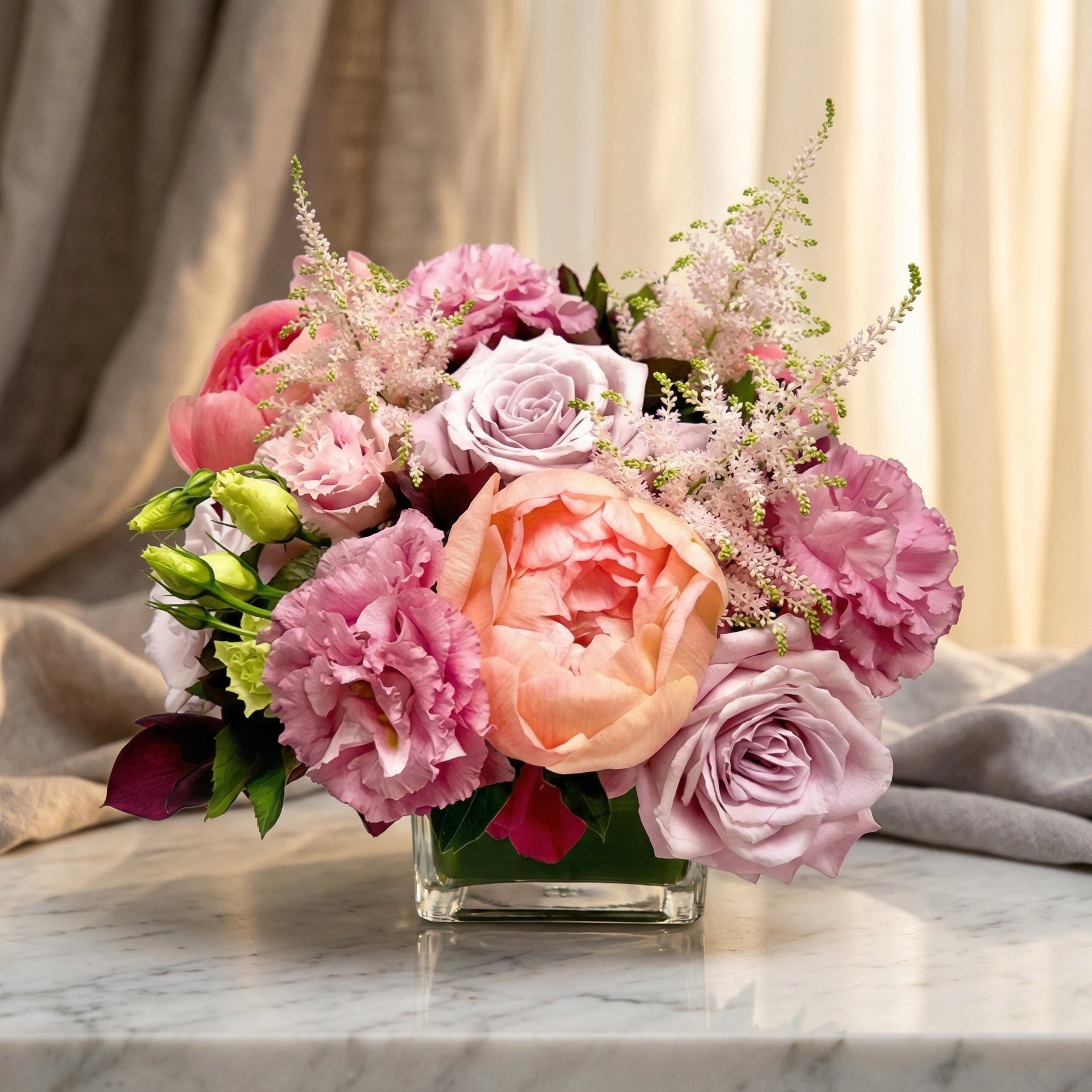Pastel bouquet with roses, peonies, and astilbe in a square glass vase - TJ Flowers NYC