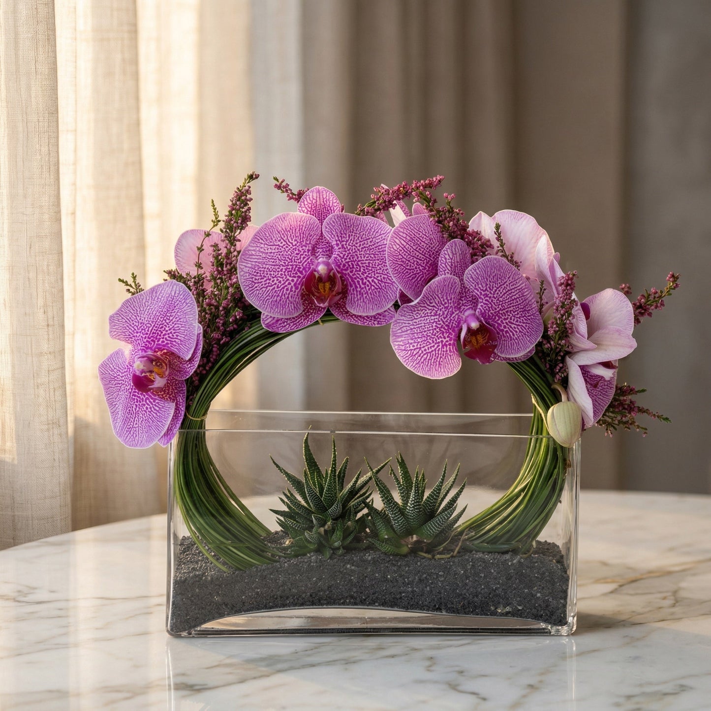 Modern arrangement with pink phalaenopsis orchids and succulents in a clear glass vase - TJ Flowers NYC