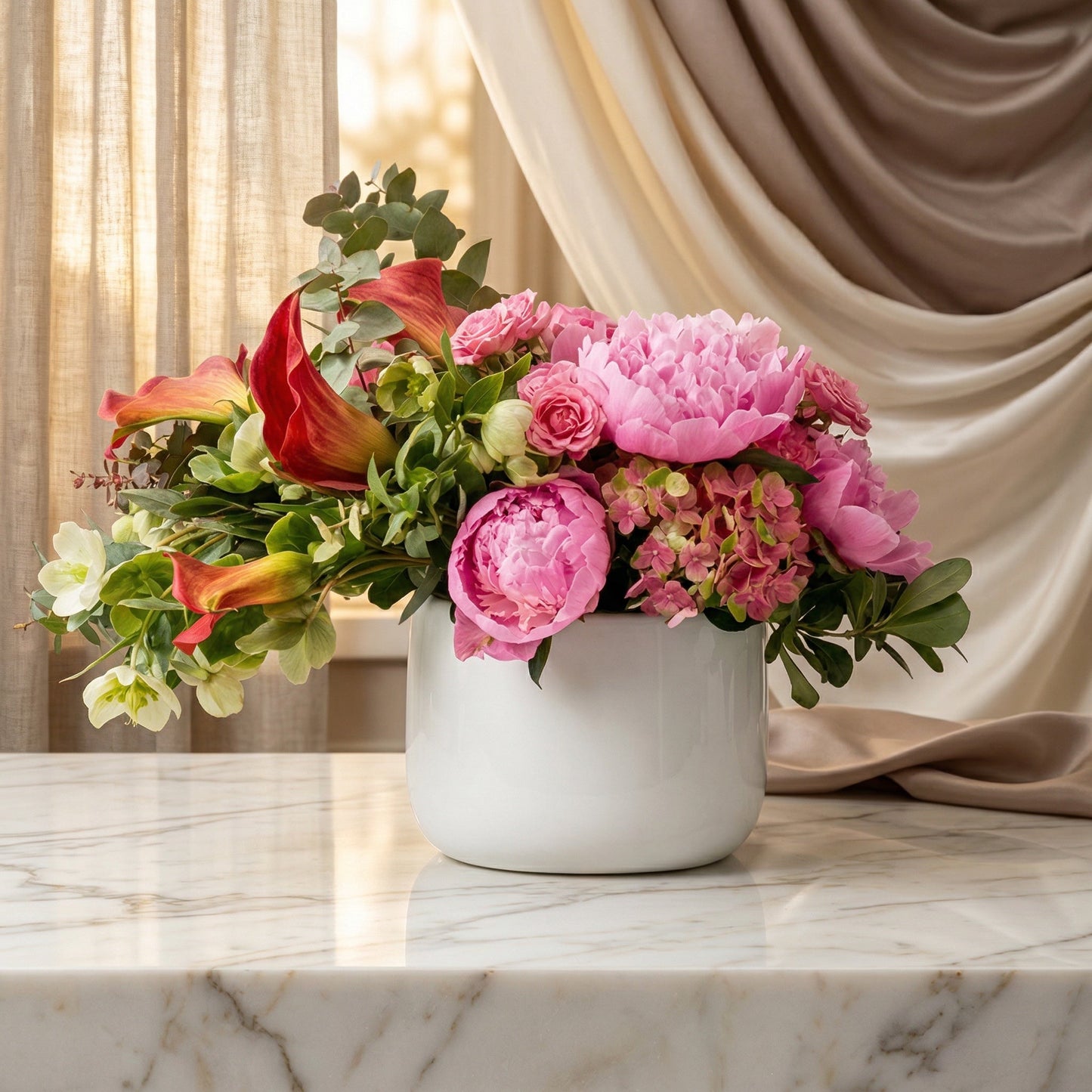 Pink peonies, roses, and red calla lilies in a white ceramic vase on a marble table - TJ Flowers NYC