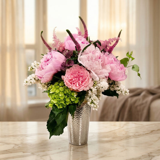Pink peonies, green hydrangea, and white lilac in a textured silver vase - TJ Flowers NYC