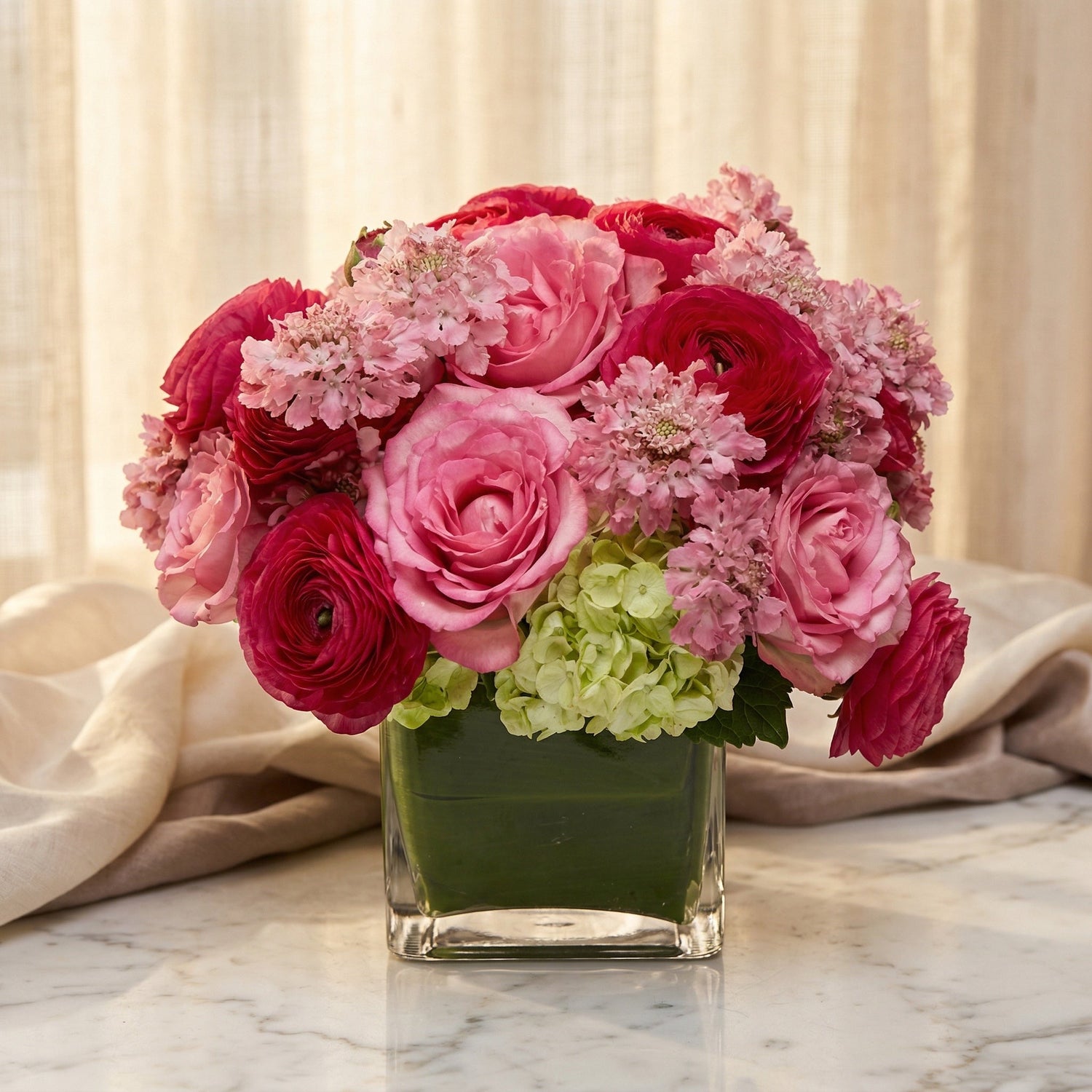 Pink roses, ranunculus, and green hydrangea in a square glass vase - TJ Flowers NYC