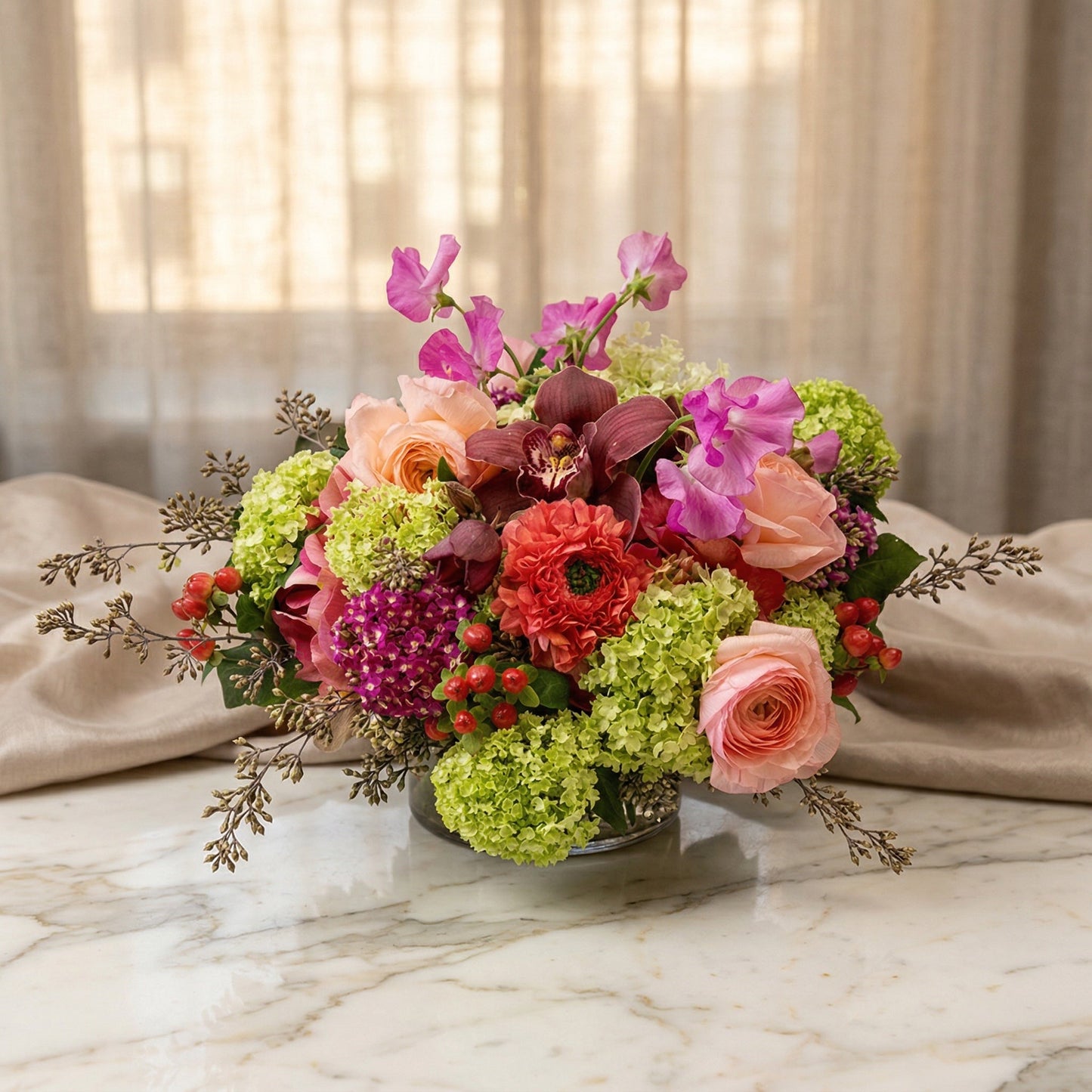 Pastel mixed bouquet with roses, orchids, and green hydrangeas in a glass vase - TJ Flowers NYC