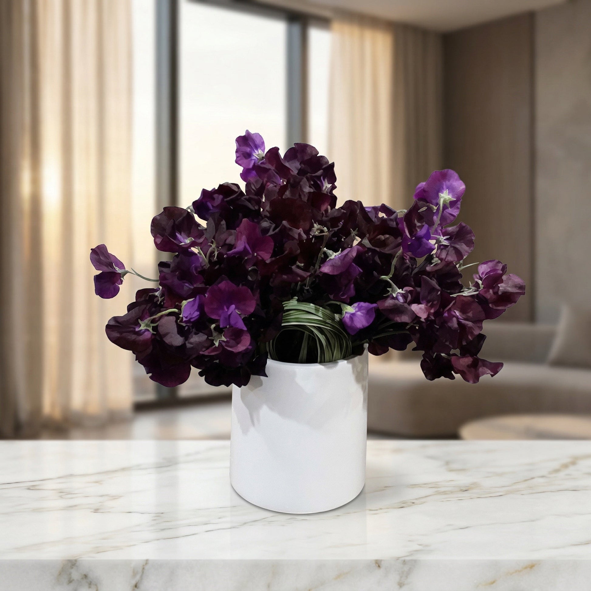 Deep purple sweet pea flowers in a modern white ceramic cylinder vase on a marble table - TJ Flowers NYC