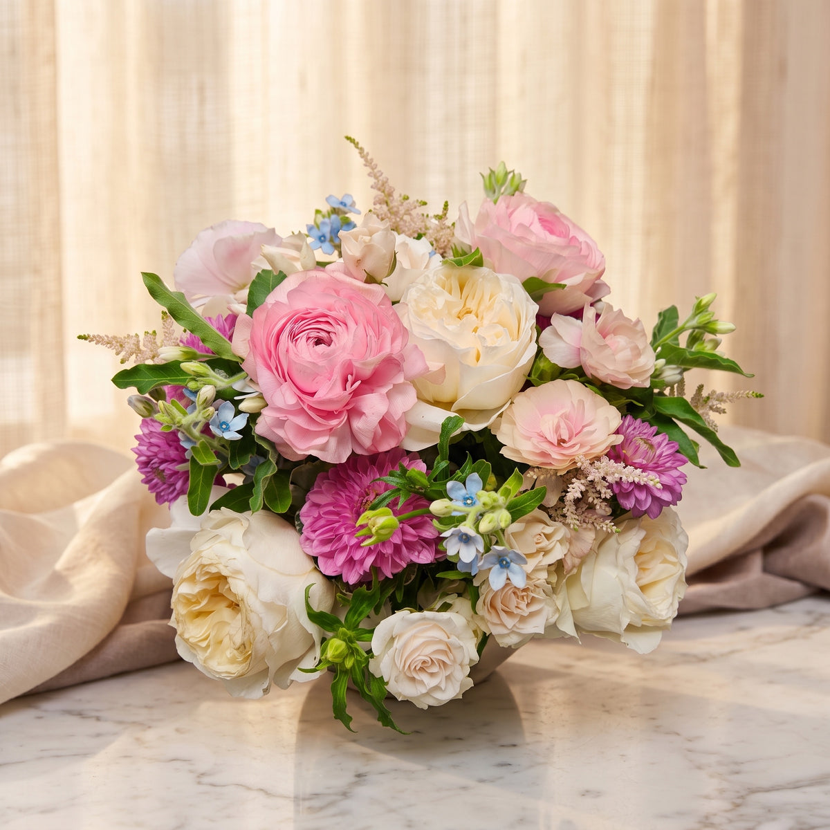 Pink ranunculus with cream garden roses, magenta dahlias and blue tweedia - TJ Flowers NYC