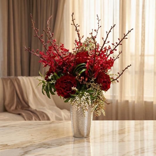 Deep red roses and orchids with white filler flowers in a hammered silver vase - TJ Flowers NYC