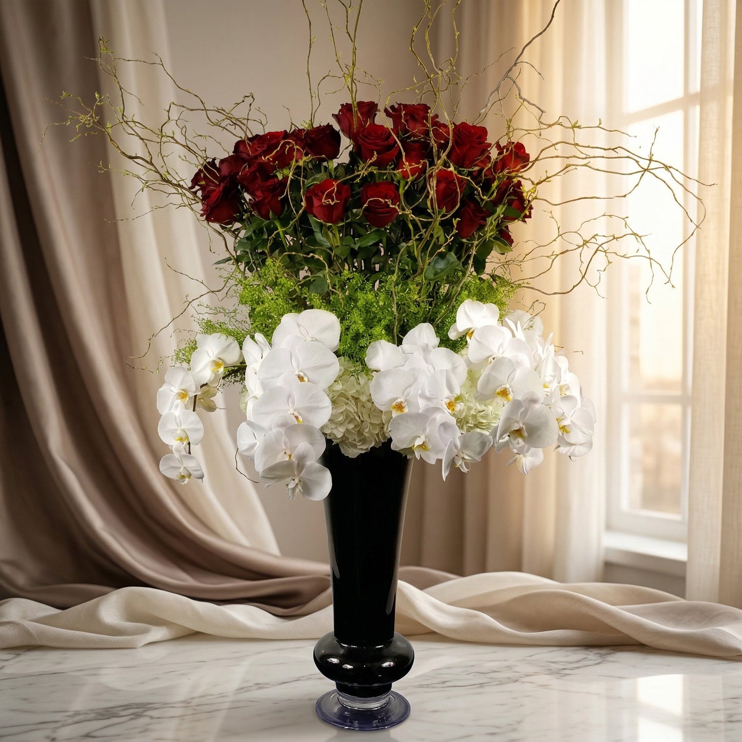 Red roses and white phalaenopsis orchids in a tall black vase with curly willow branches - TJ Flowers NYC