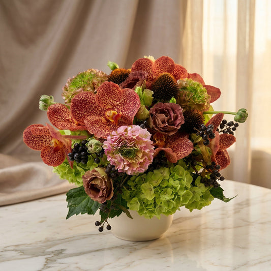 Red spotted orchids, green hydrangeas, and pink ranunculus in a white vase - TJ Flowers NYC