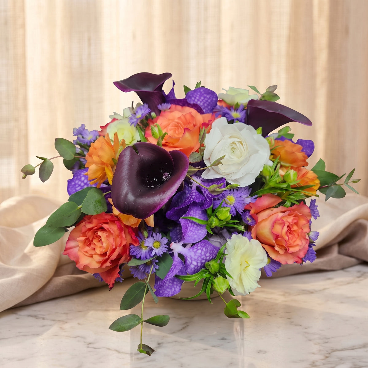 Violet vanda orchids with plum calla lilies, orange roses and white ranunculus - TJ Flowers NYC