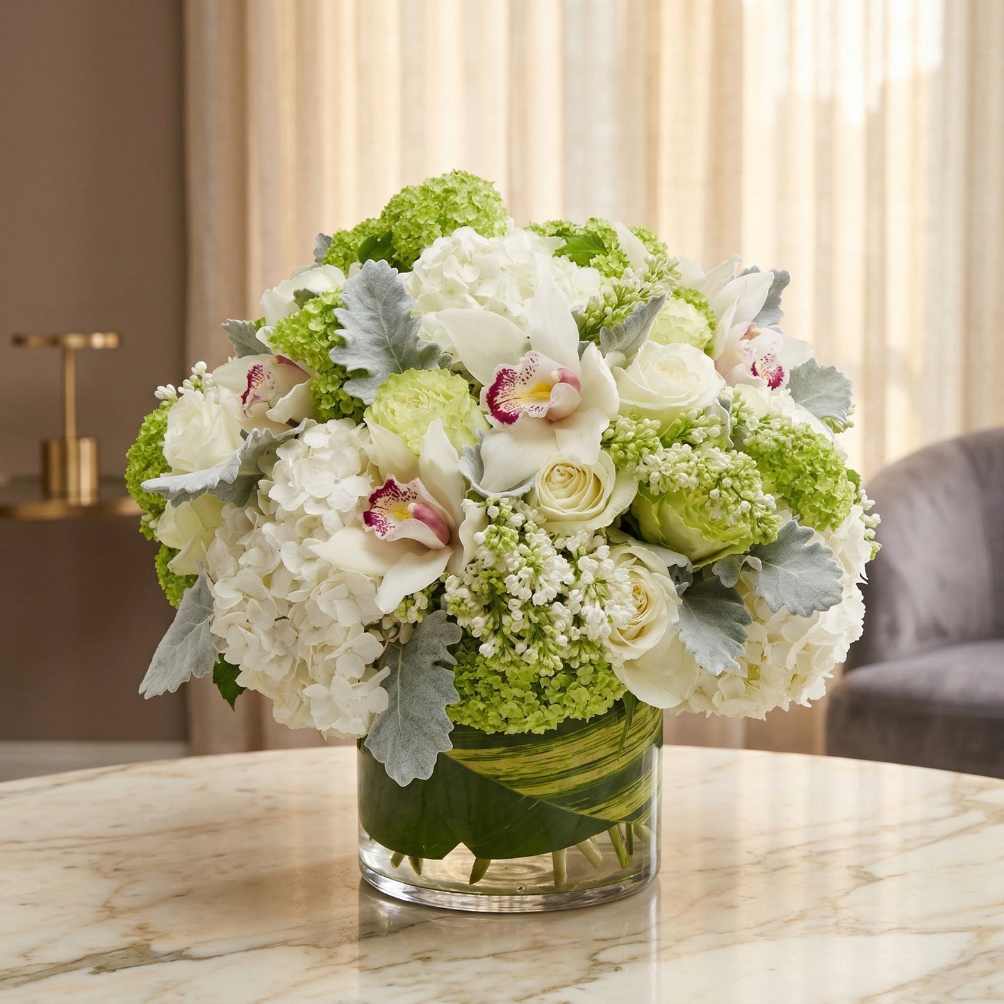 White orchids, roses, and green hydrangeas in a clear glass cylinder vase with leaf wrap - TJ Flowers NYC