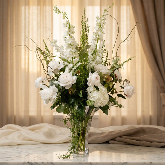 Elegant white peony and hydrangea arrangement in a glass vase with tall delphinium - TJ Flowers NYC