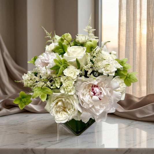 White roses and peonies with green hellebores in a modern glass vase - TJ Flowers NYC