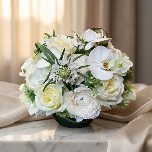 Elegant white rose and orchid bouquet in a dark vase on a marble table - TJ Flowers NYC