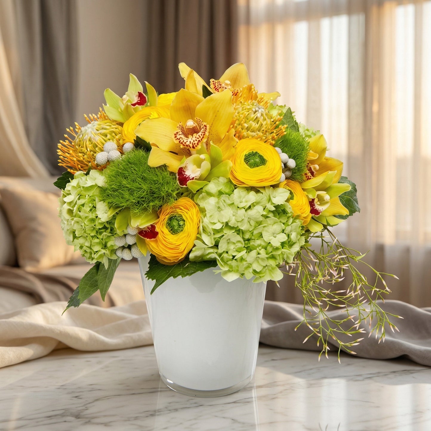 Yellow orchids, green hydrangeas, and ranunculus in a white vase - TJ Flowers NYC